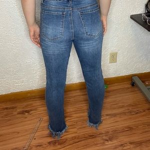 Blue skinny jeans with fringe on the end